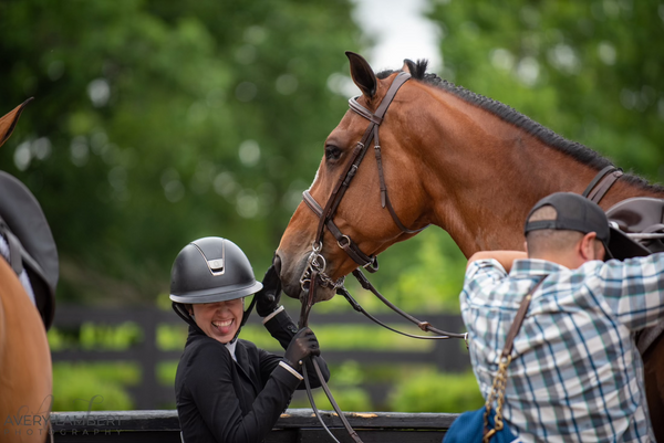 Kate sticking out her tongue with her horse